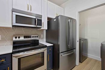a kitchen with stainless steel appliances and white cabinets